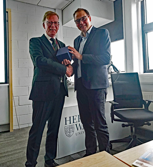 Professor Edward Sweeney (Left) presenting Dr. Scott Arthur with an engraved glass as a memento of the event.